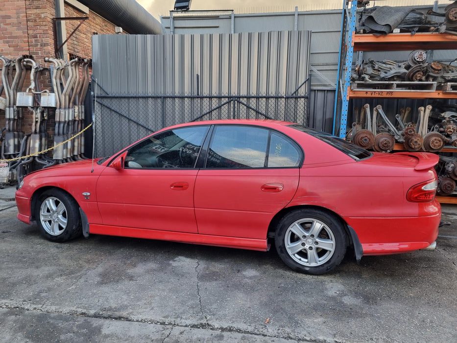 A206 - VX HOLDEN COMMODORE SEDAN - PASSENGER SIDE MIRROR RED HOT #F143