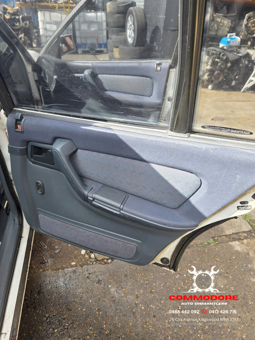 VN / VG / VP / VR / VS Holden Commodore - DRIVER'S SIDE - Kick Panel Cloth / Dark Grey - Part #92055612