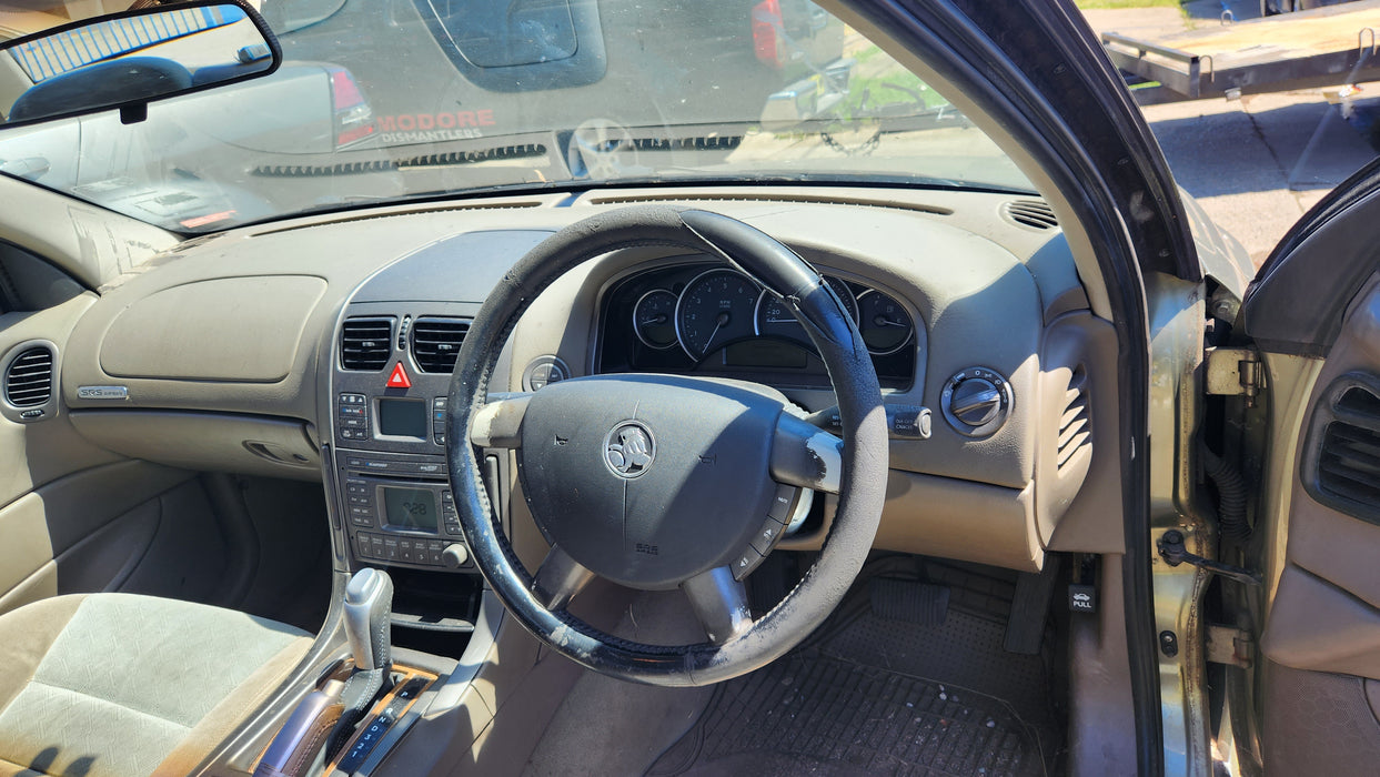 VT / VX Holden Commodore - DRIVER'S SIDE - Kick Panel / Beige Cloth - Part #92047030