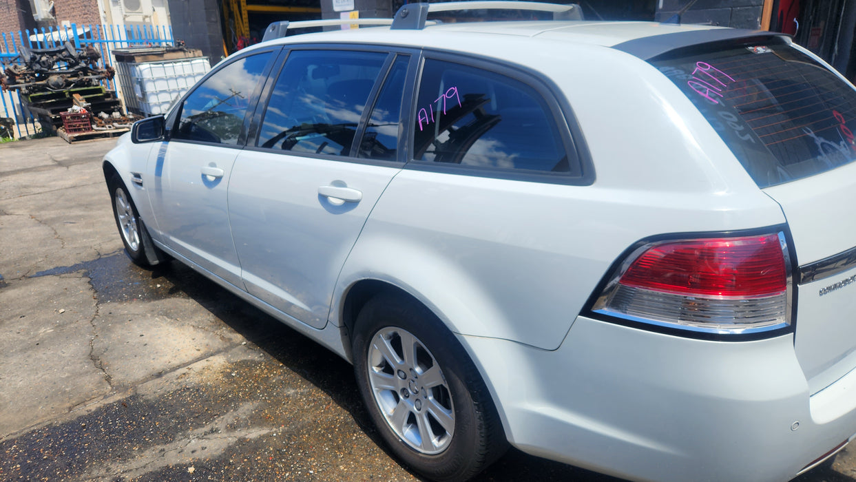 A179 - VE HOLDEN COMMODORE Omega Wagon - Fuel Flap HERON WHITE #679F