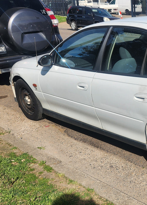 A231 - VT / VX Holden Commodore SEDAN - Front Passenger's Door (POWER WINDOWS)- HERON WHITE #J023