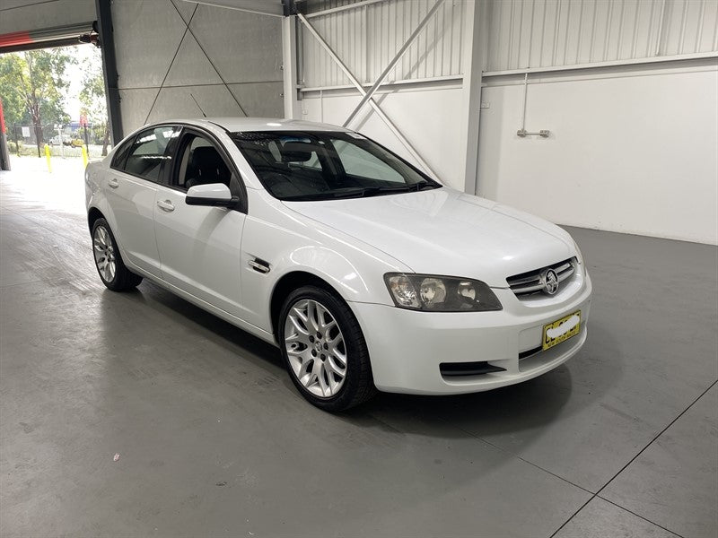 A065 - VE HOLDEN COMMODORE SEDAN - FUEL FLAP - HERON WHITE 679F